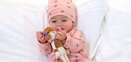 Image of baby with plush toy