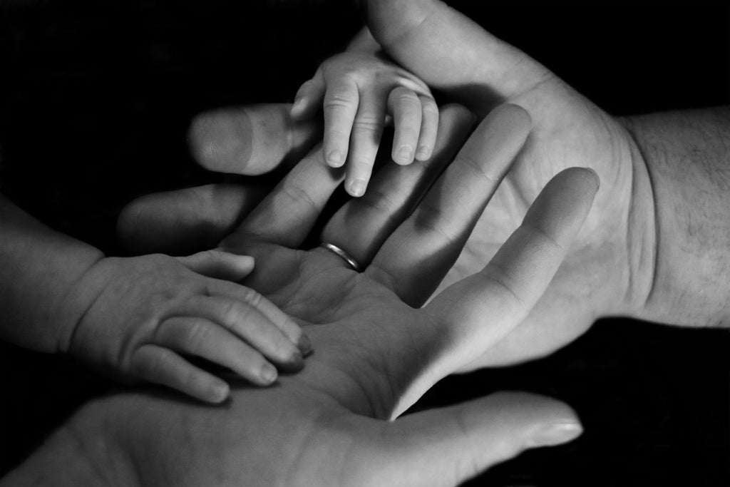 image of parents and baby's hands